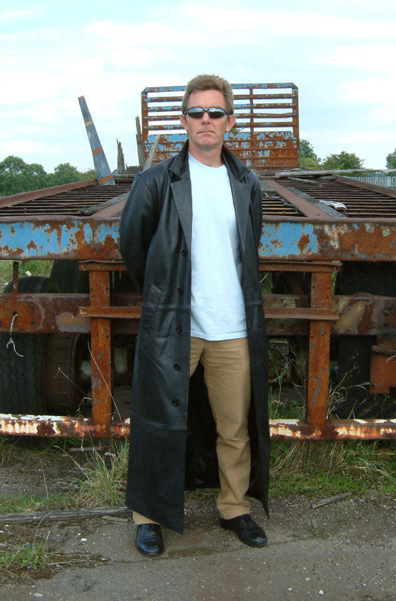 Modern black trench coat demonstrating the long belted trench silhouette
