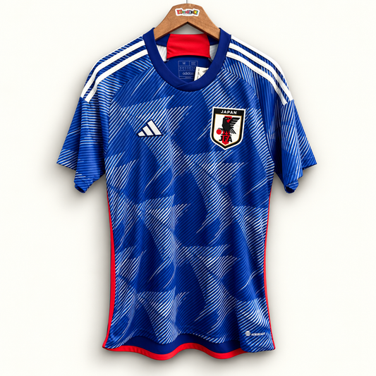 Adidas Japan blue and white jersey on off white editorial background