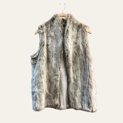 BCBG grey faux fur vest on warm off white editorial background