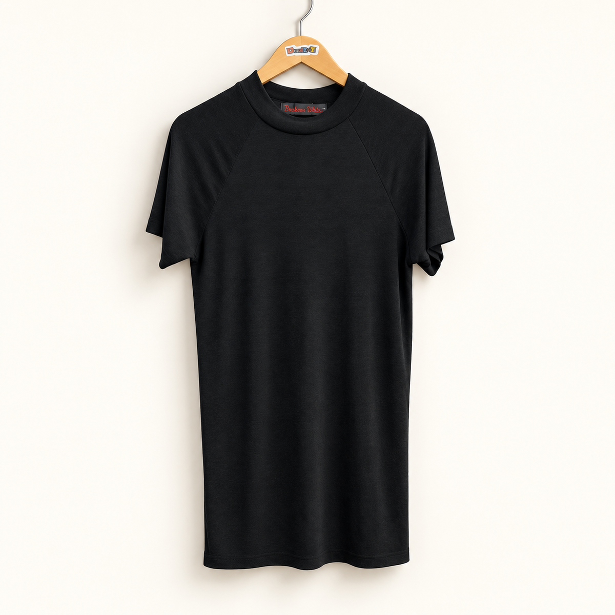 Black mock neck short sleeve shirt on warm off white editorial background