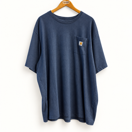 Carhartt blue pocket tee on warm off white editorial background