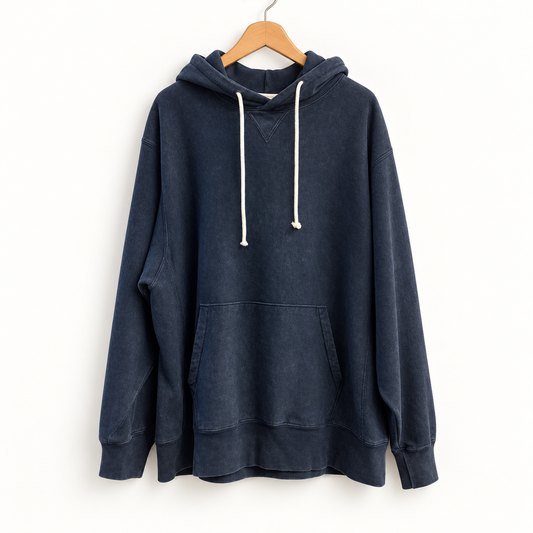 Champion navy hoodie on warm off white editorial background