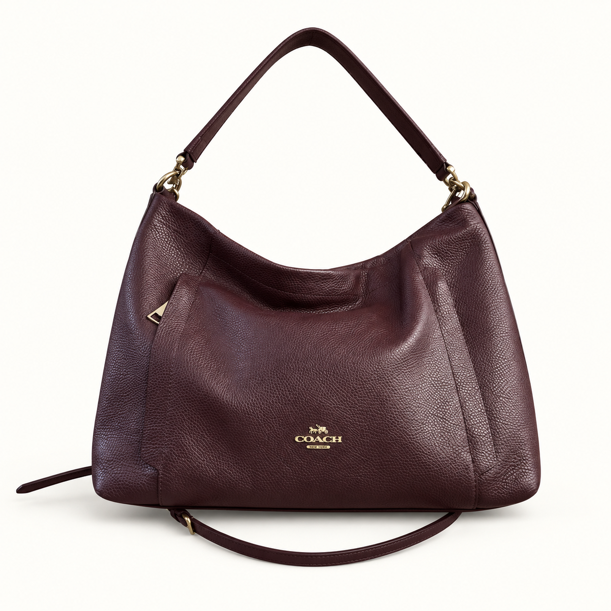 Coach burgundy leather shoulder bag on off white editorial background