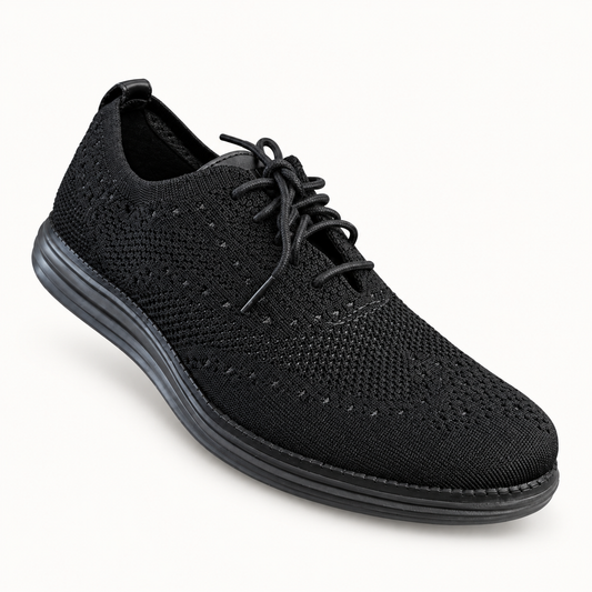 Cole Haan black knit sneaker on off white background