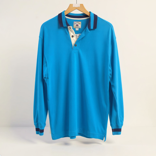 Cutter and Buck Long Sleeve Rugby Polo on off-white editorial background