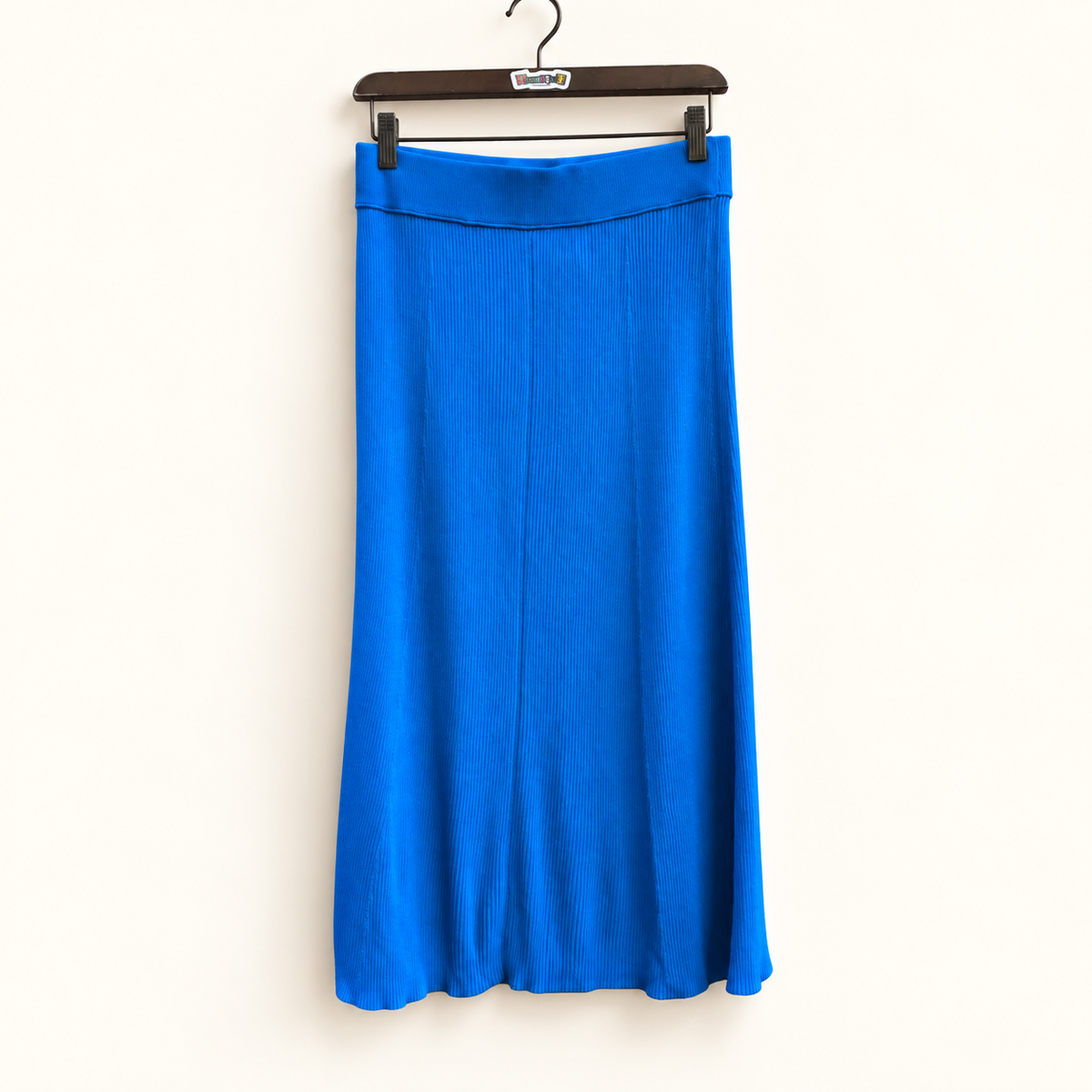 Everlane blue ribbed midi skirt on warm off white editorial background