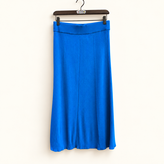 Everlane blue ribbed midi skirt on warm off white editorial background