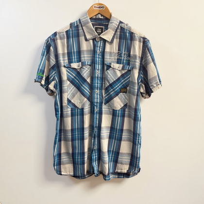 G Star Raw blue and white plaid button down shirt on off white editorial background