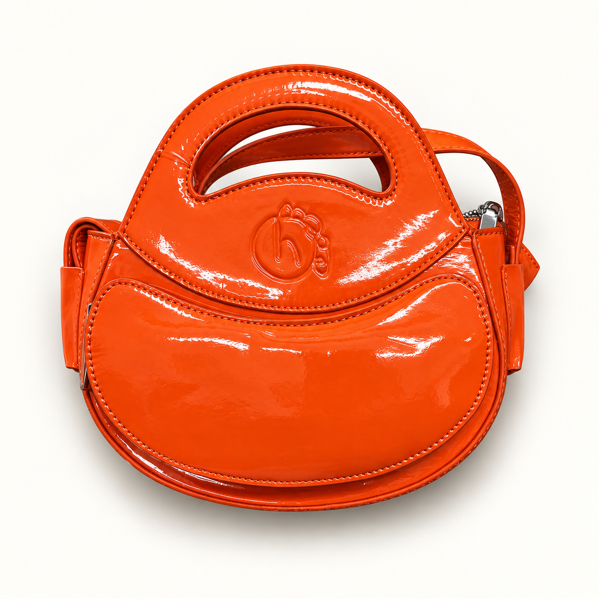 Homage Year orange Ovum bag on off white editorial background