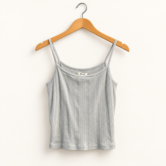 Madewell sage green ribbed tank top on warm off white editorial background