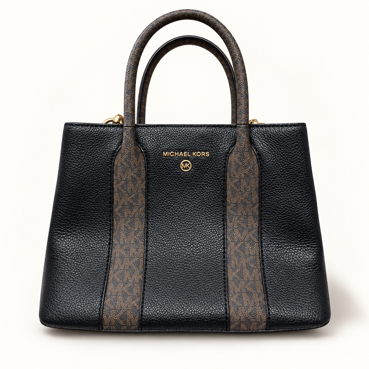 Michael Kors black and brown monogram bag on off white editorial background