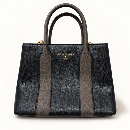 Michael Kors black and brown monogram bag on off white editorial background