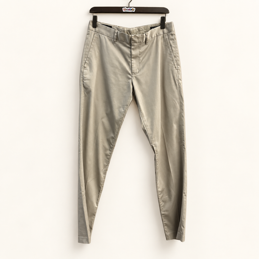 Nordstrom khaki trousers on warm off white editorial background