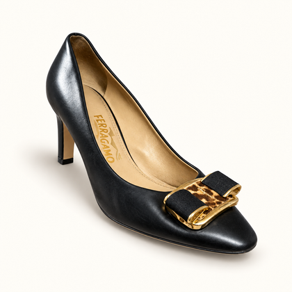 Salvatore Ferragamo black leather heels on off white editorial background