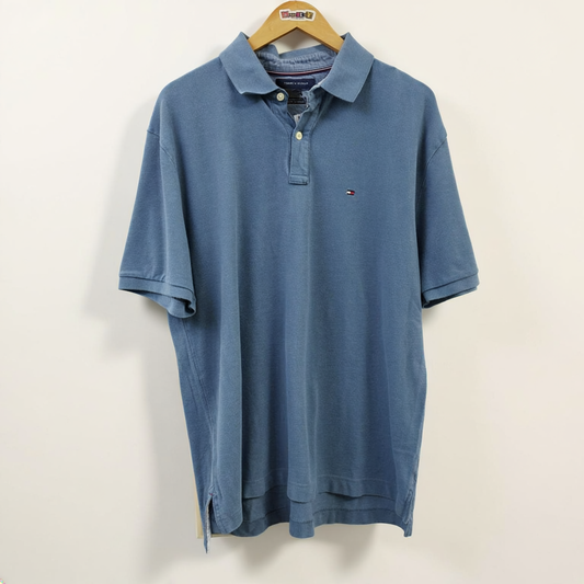 Tommy Hilfiger blue polo on off white editorial background