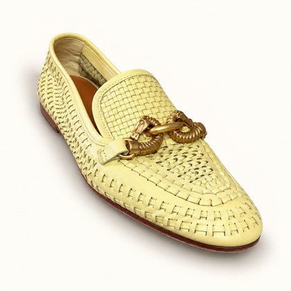 Tory Burch beige woven loafers on off white editorial background