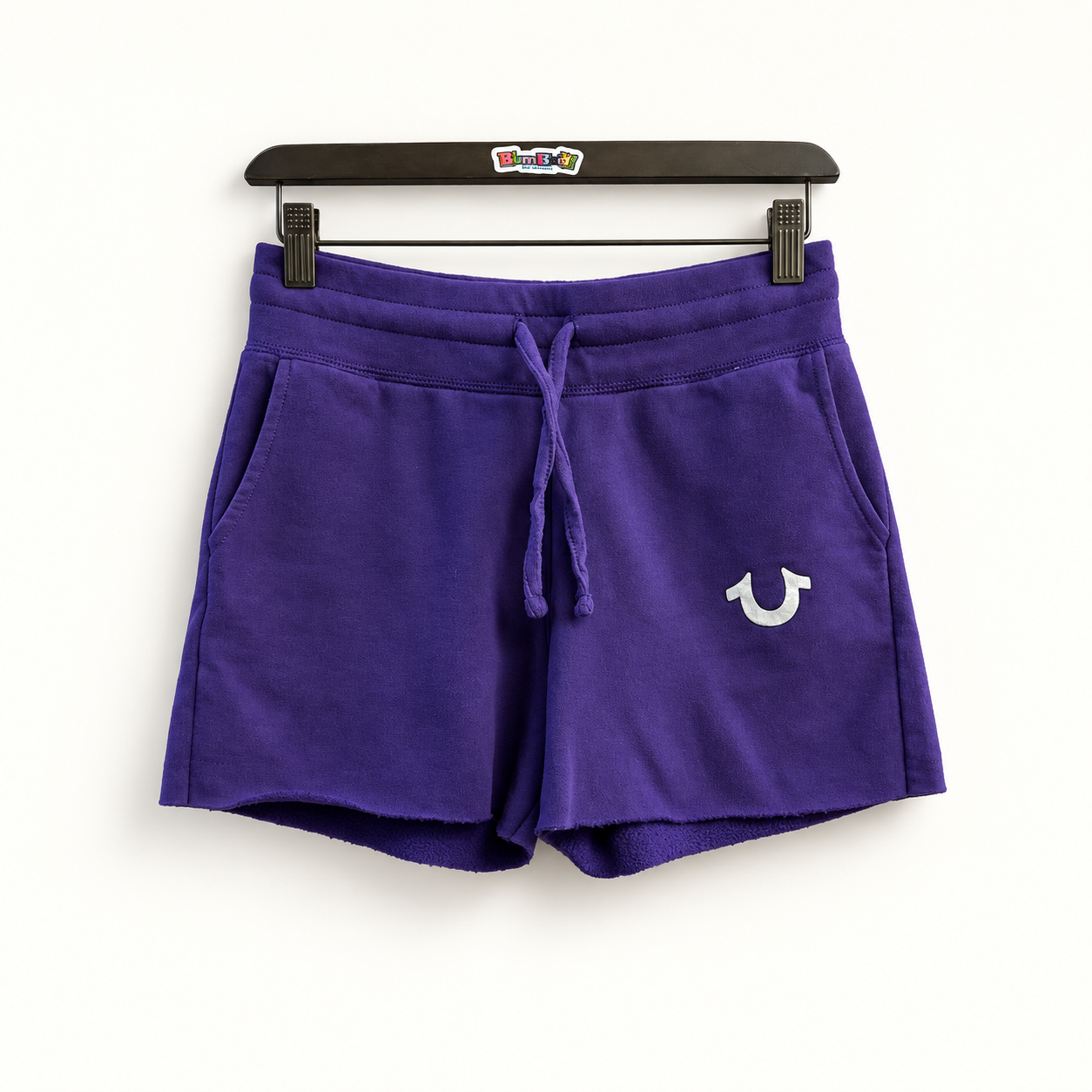 True Religion purple lounge shorts on off white editorial background
