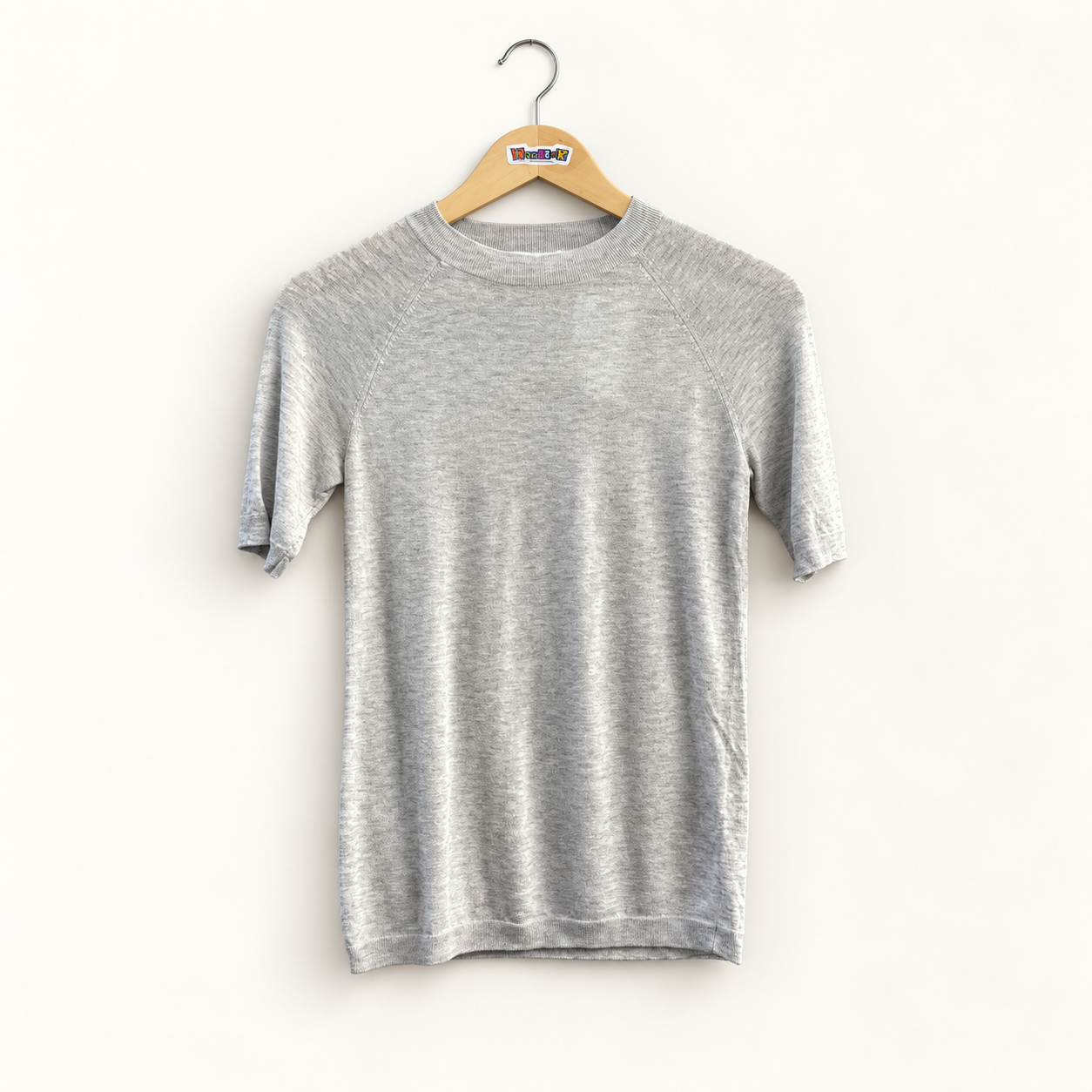 Vince grey short sleeve sweater top on off white editorial background